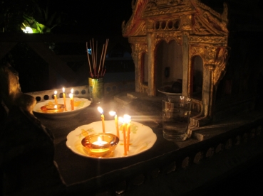 Our spirit house by candlelight.